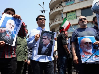 Un grupo de personas muestra imágenes de los científicos Mohammad Mehdi Tehranchi (izquierda) y Fereydoun Abbasi-Davani (centro) y del general Gholam Ali Rashid (derecha), muertos en el ataque de Israel, el viernes durante una protesta en Teherán. 